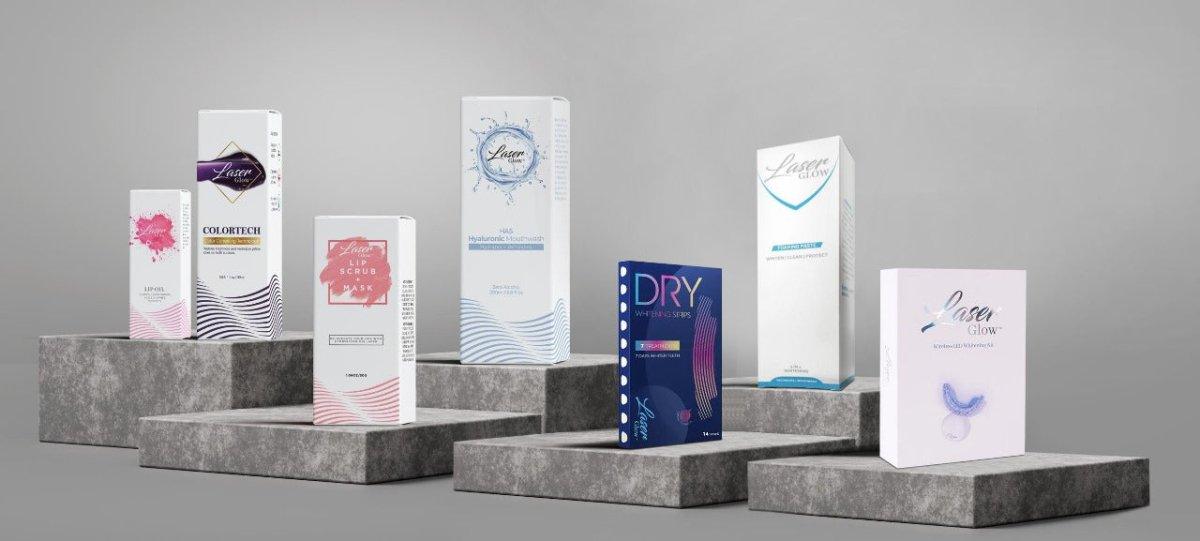 LaserGlow professional teeth whitening business supplies displayed on tiered platforms, including whitening strips, LED trays, mouthwash, lip care, and ColorTech gel kits