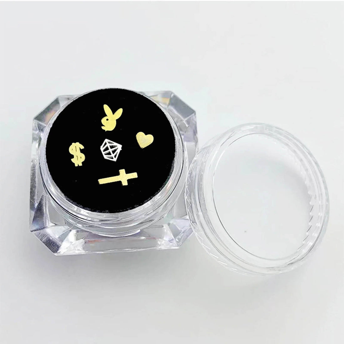 Clear acrylic display box with velvet cushion showcasing assorted LaserGlow butterfly, heart.