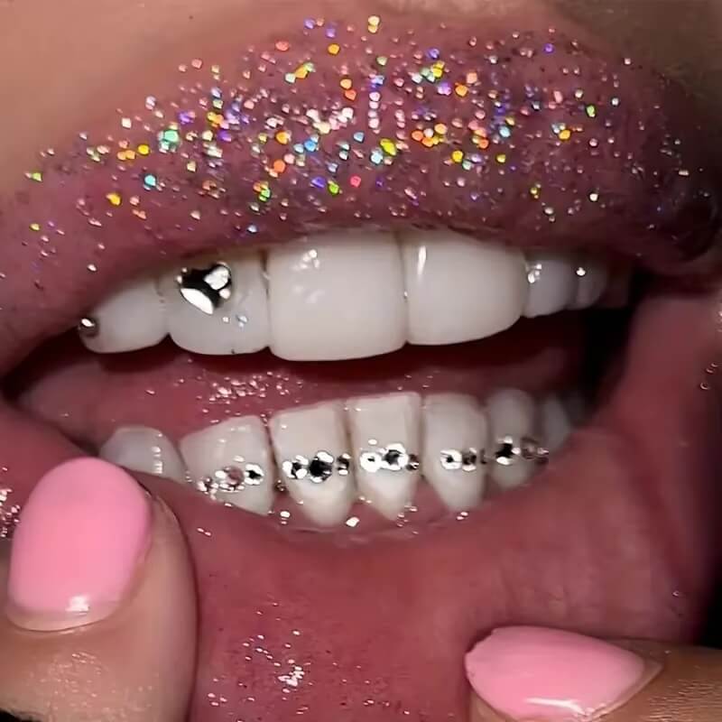 Close-up of LaserGlow heart-shaped tooth gem sparkling on a canine tooth, showcasing enamel-saf.