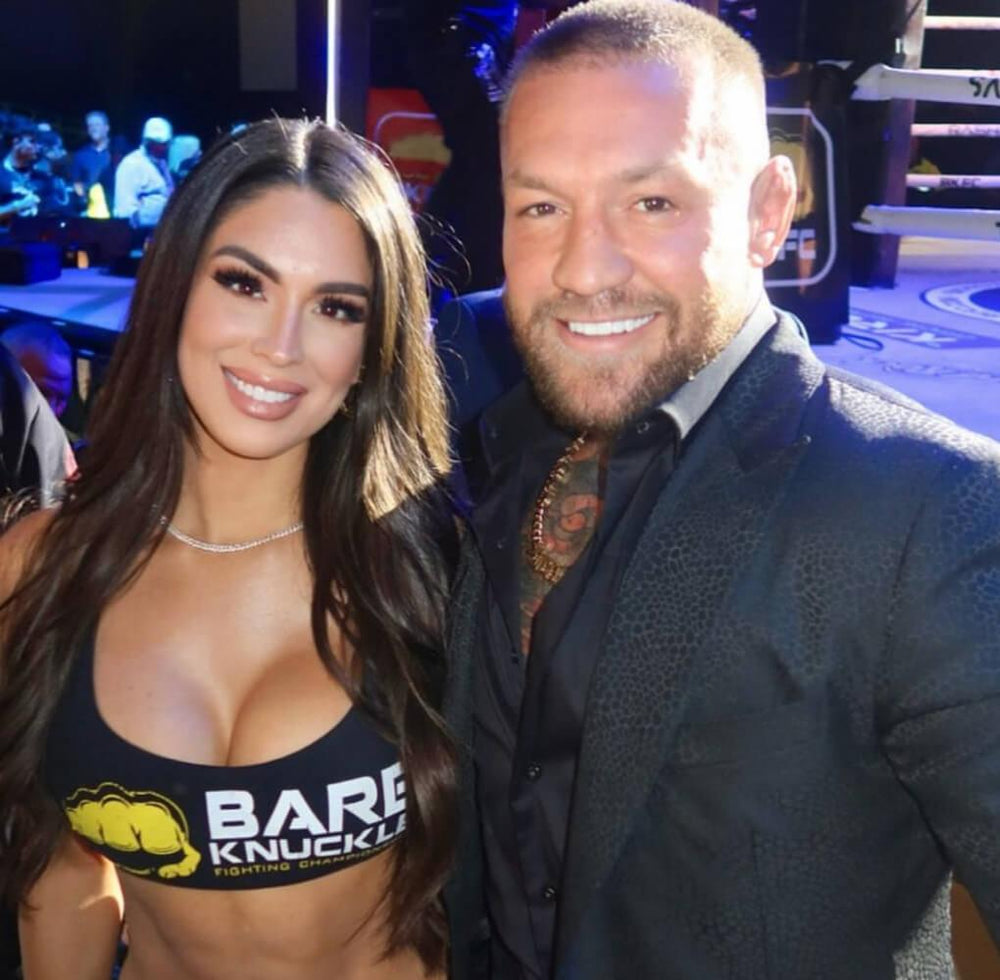 Conor McGregor and Alyssa the ring girl smiling at LaserGlow teeth whitening event