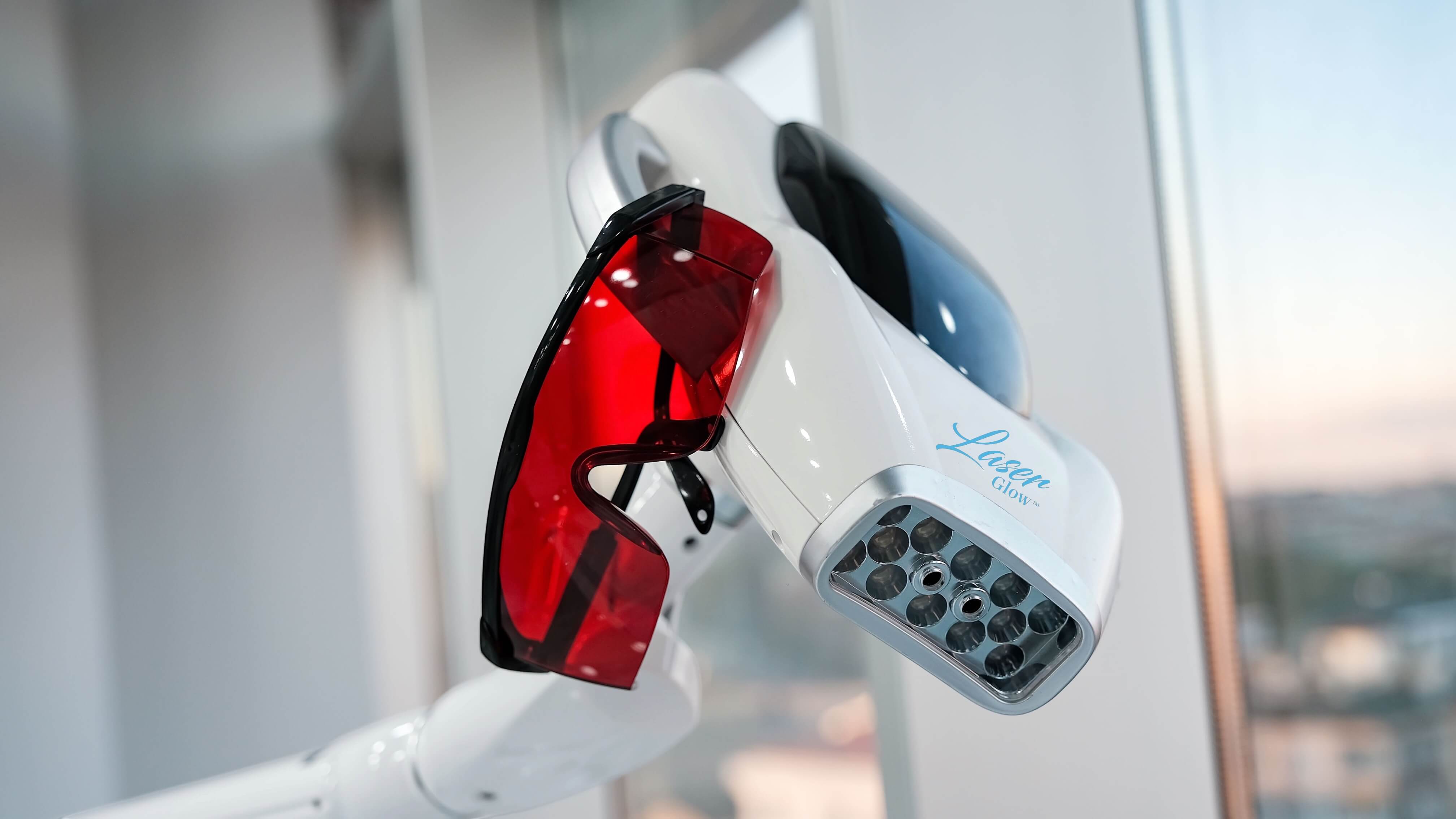 Professional LED teeth whitening machine with red protective goggles, professional whitening equipment for med spas, salons, and dental teams from LaserGlow.