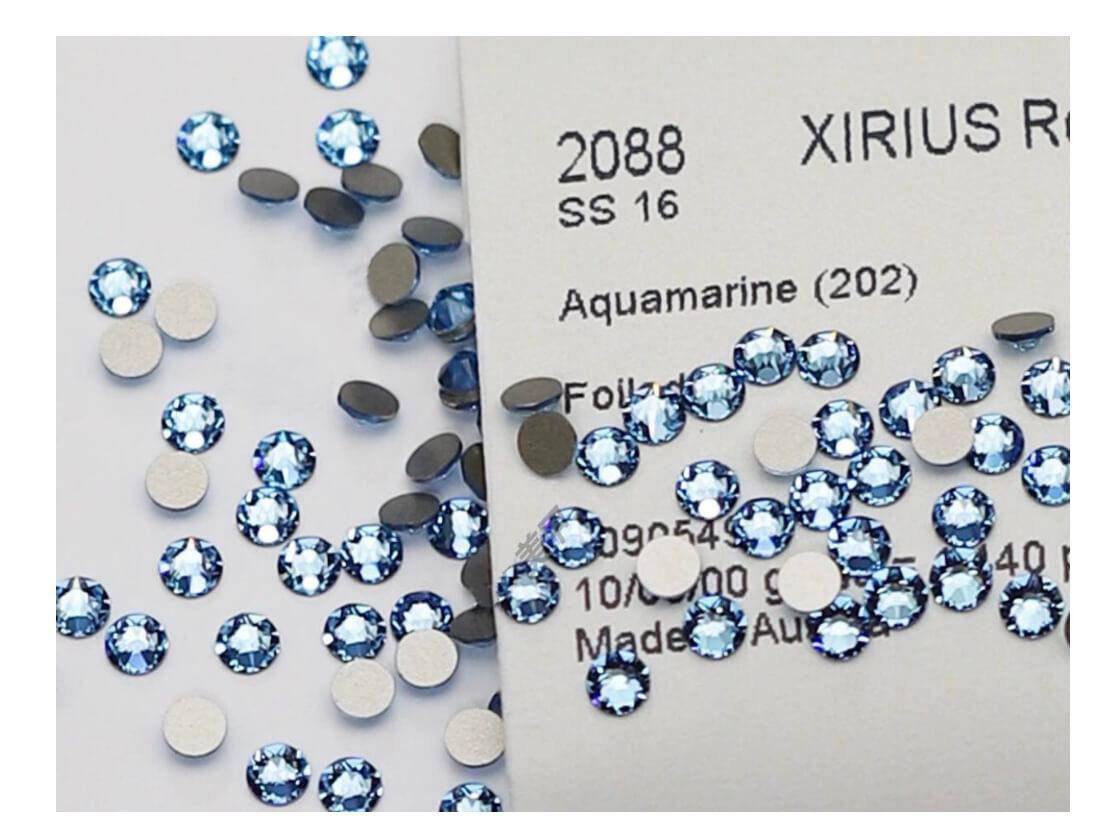 Brilliant blue LaserGlow Swarovski Tooth Gem adding a cool, striking accent to a radiant smile.