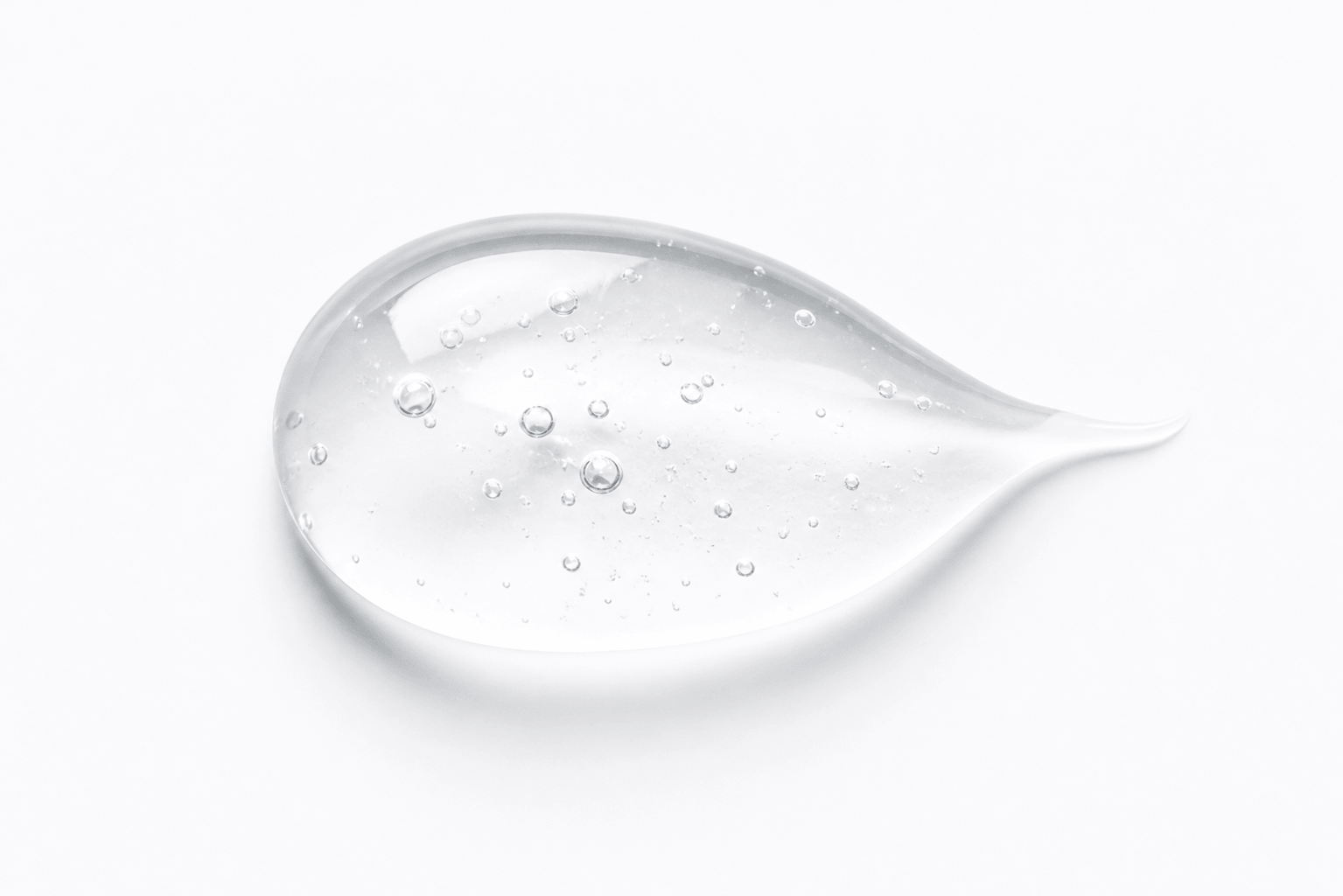 Close-up of clear teeth whitening gel drop showing smooth carbamide peroxide gel texture on a clean white background.
