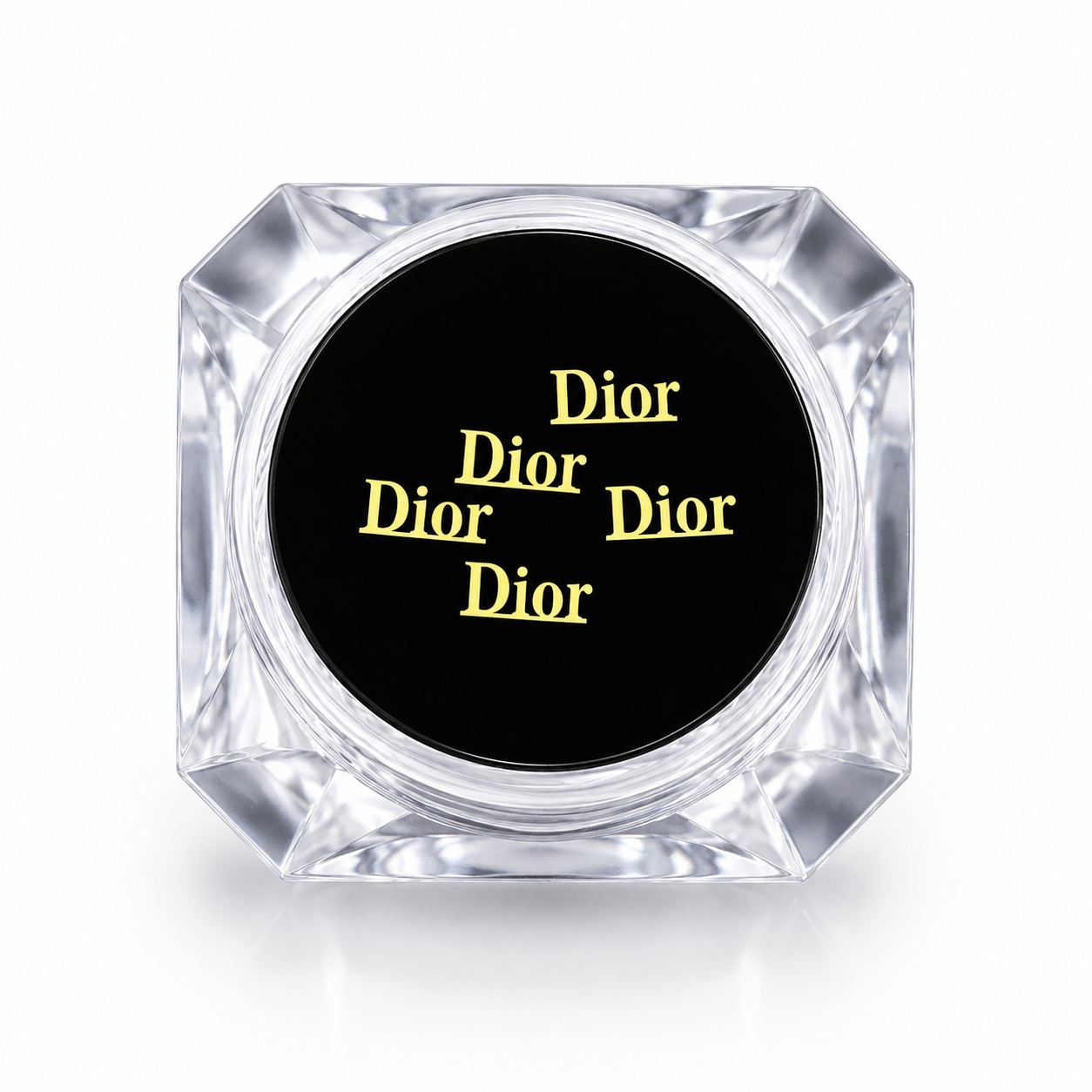 Dior inspired gold designer tooth gems displayed in a clear acrylic storage case with a black insert for professional tooth gem services