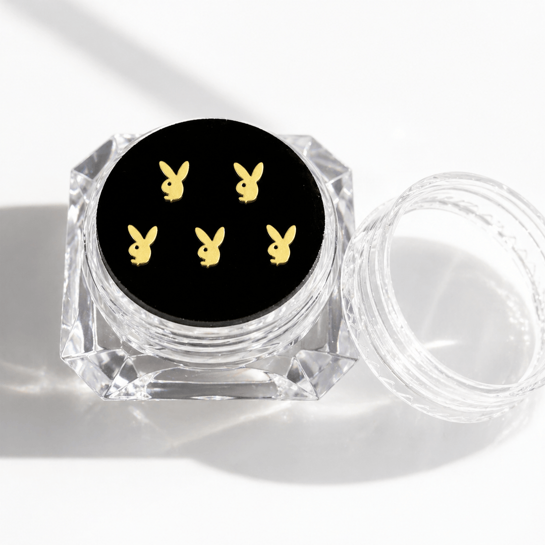 Gold bunny tooth gems 5-piece set displayed in a clear acrylic case with black insert for a polished product page image.
