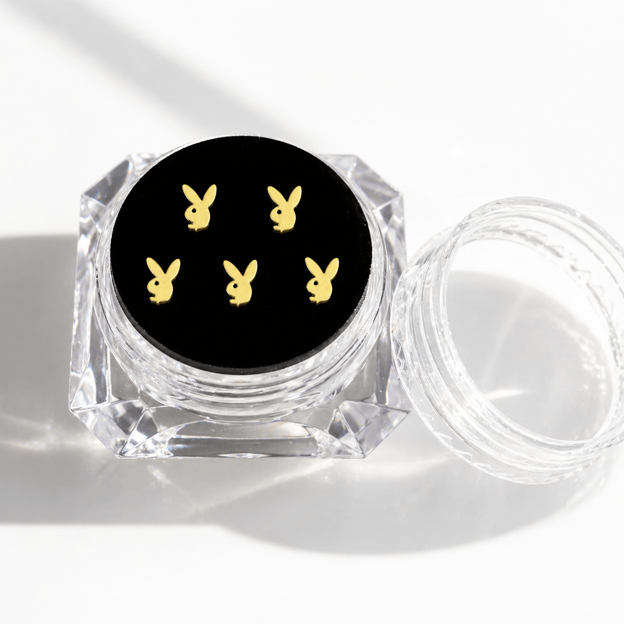Gold bunny tooth gems 5-piece set displayed in a clear acrylic case with black insert for a polished product page image.