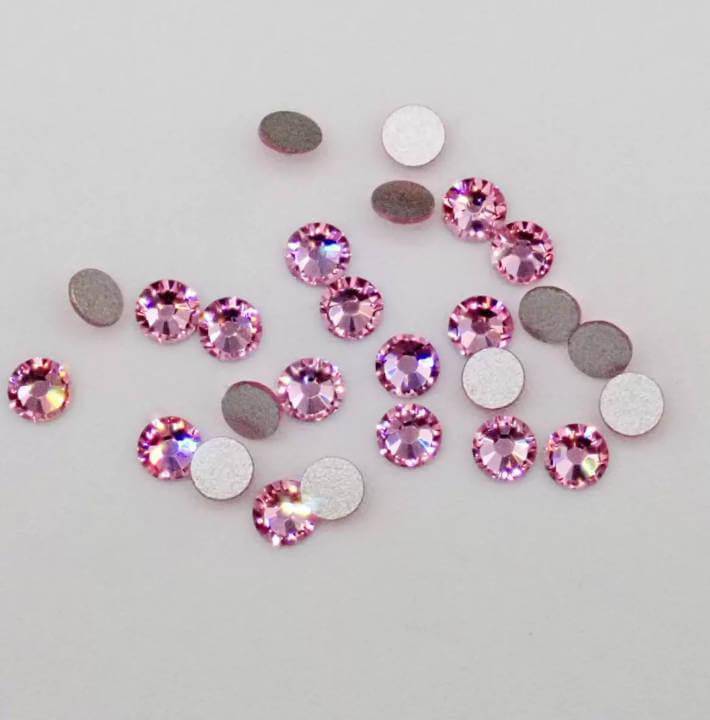 Elegant purple LaserGlow Swarovski Tooth Gem creating a bold, sophisticated sparkle on a smile