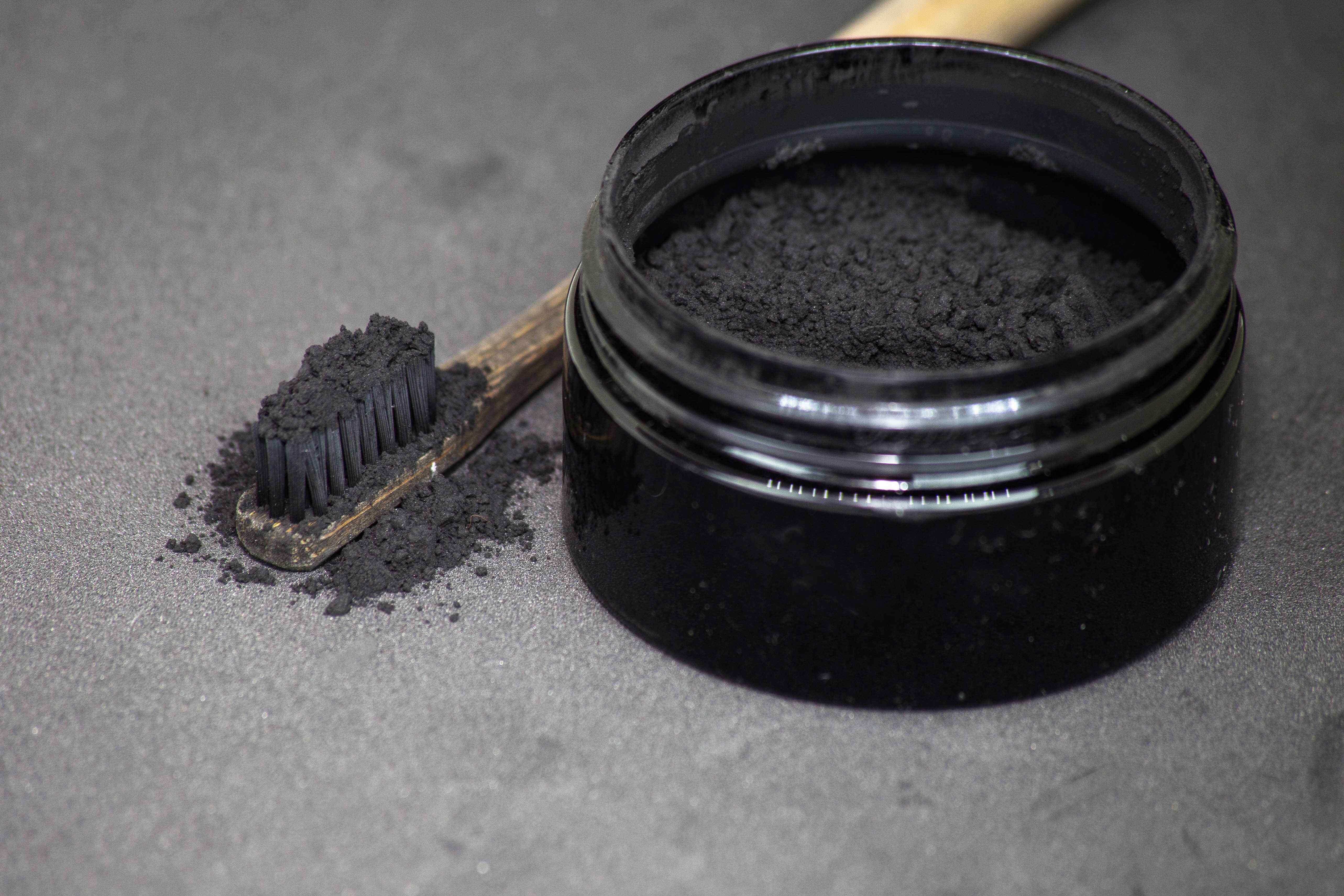 LaserGlow Activated Charcoal Teeth Whitening Powder in jar – natural enamel-safe whitener to remove stains from teeth