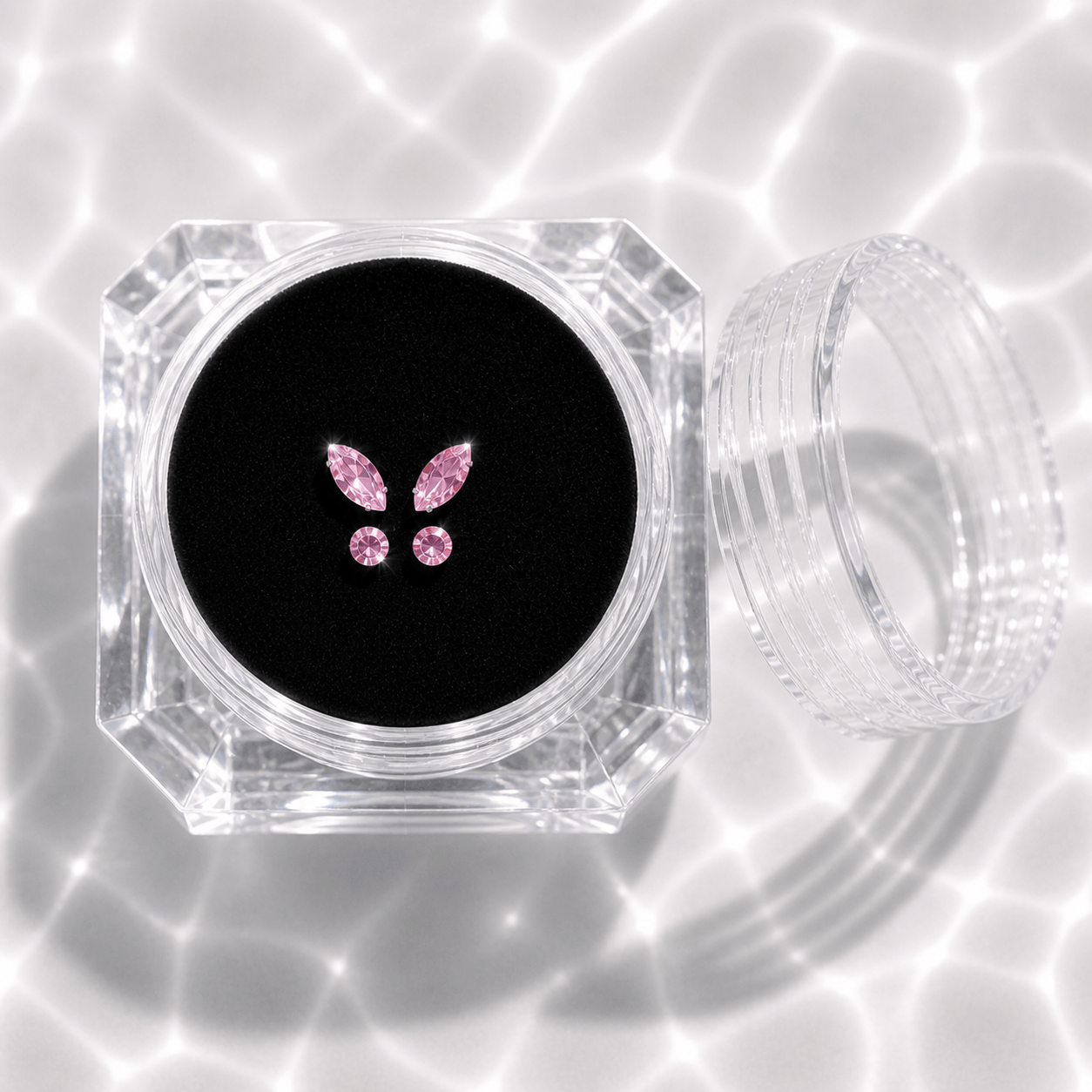 LaserGlow pink butterfly tooth gems in acrylic display case with black velvet insert, 4 piece flat-back crystal set with two wing gems and two round gems