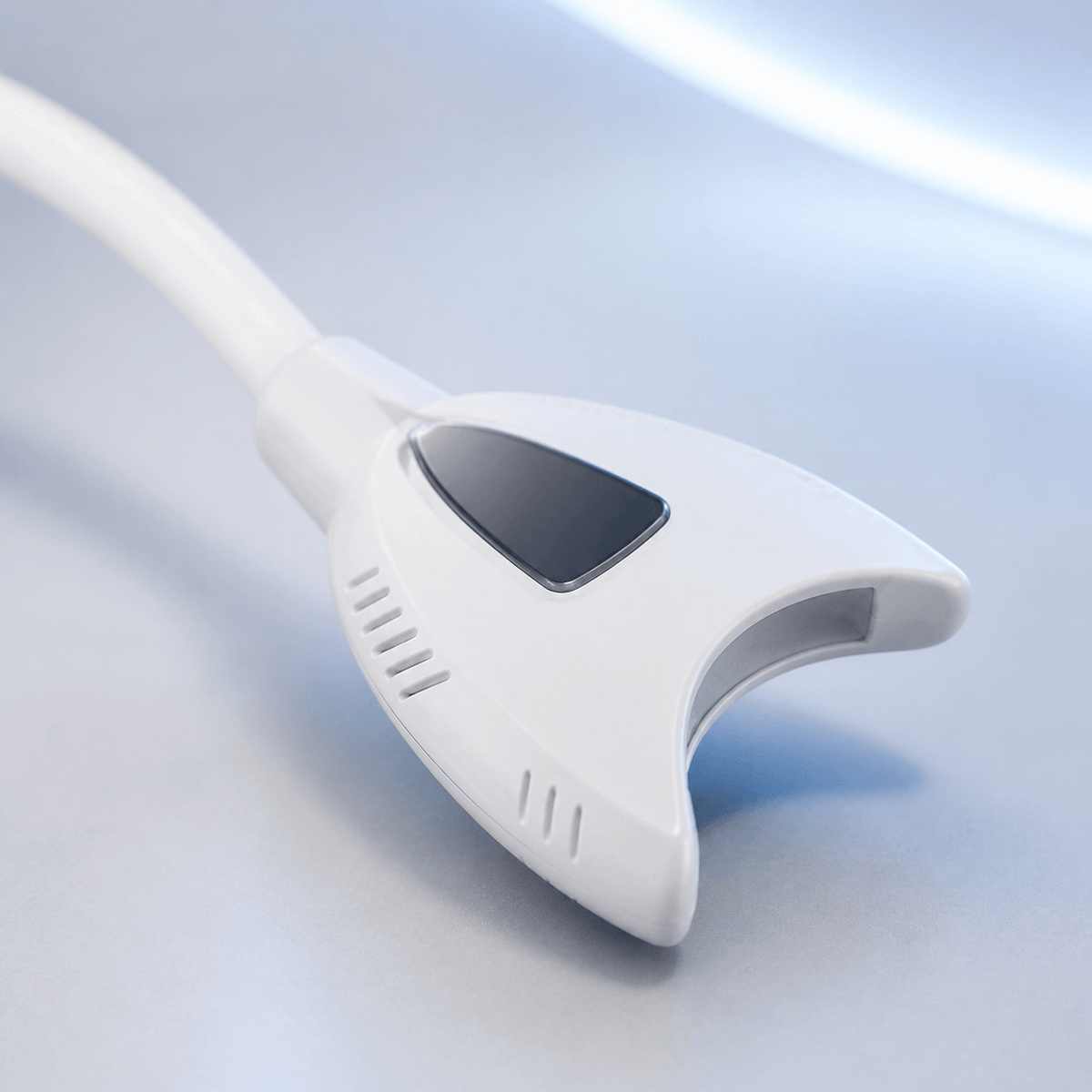 Close-up of LaserGlow professional teeth whitening lamp head on flexible arm