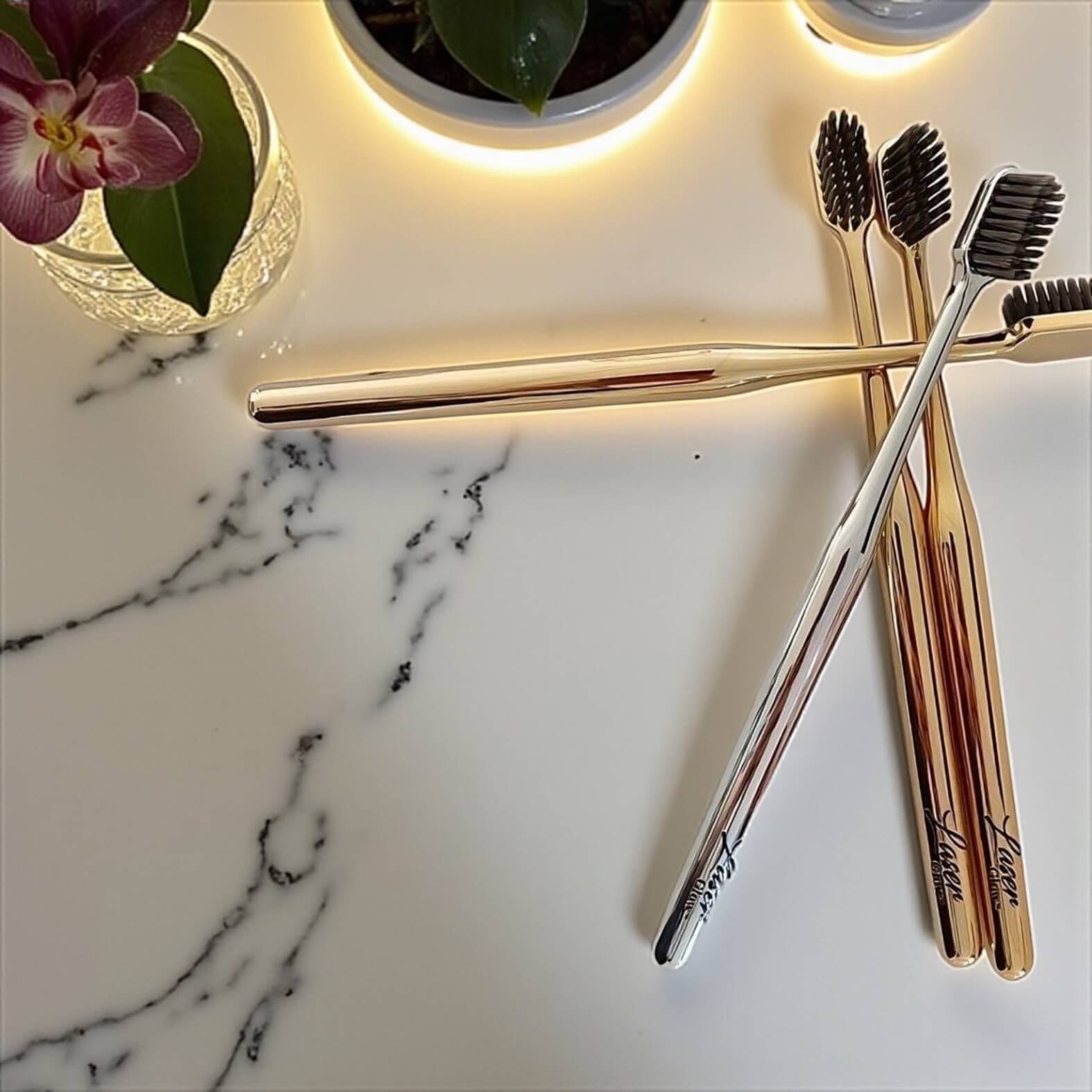 LaserGlow soft bristle electroplated gold and silver toothbrush set designed for gentle, enamel-safe cleaning and luxury oral care.