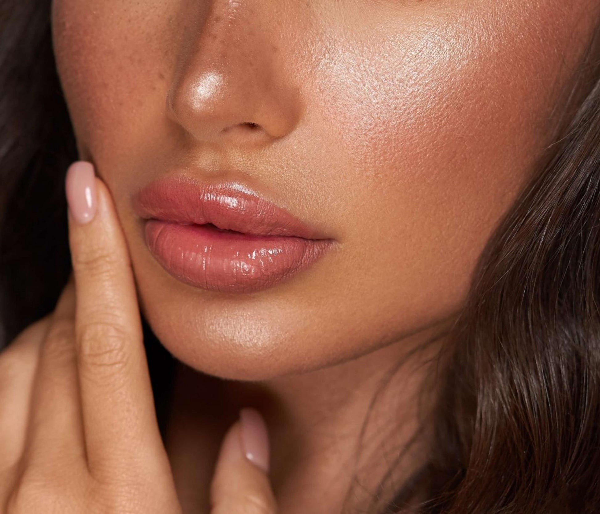 Close-up of lips with LaserGlow Lip Glaze, featuring a non-sticky formula and glossy finish.