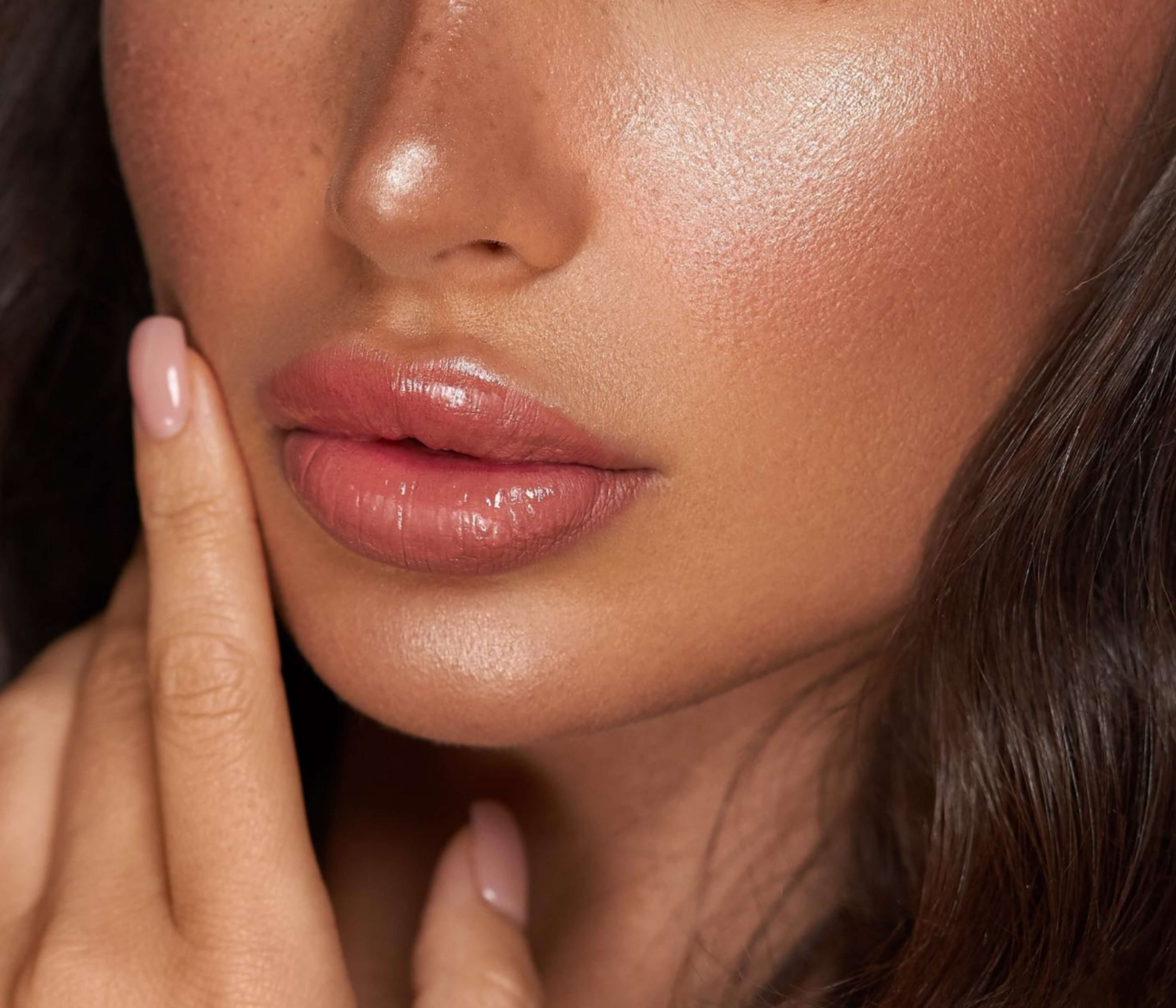 Close-up of lips with LaserGlow Lip Glaze, featuring a non-sticky formula and glossy finish.