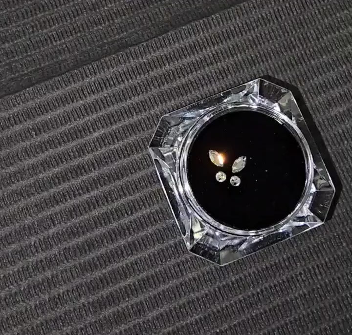 Close-up video of LaserGlow butterfly tooth gems sparkling with high-shine reflections.