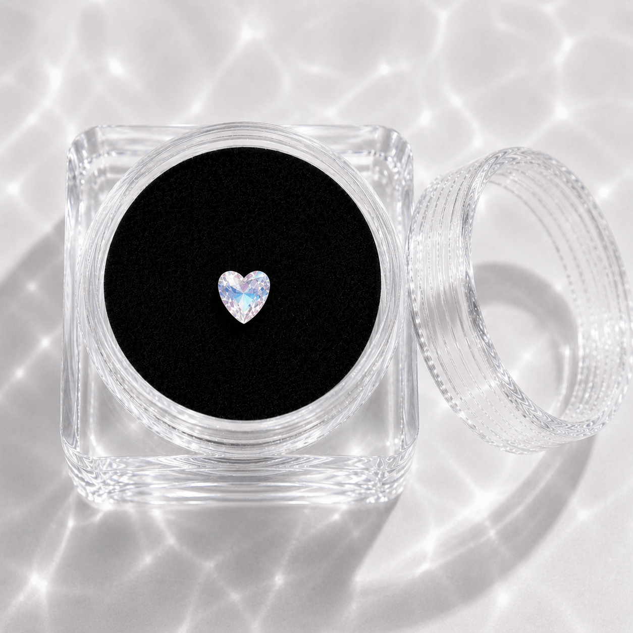 LaserGlow shimmer heart tooth gem in acrylic display case with black velvet insert, iridescent flat-back crystal for tooth jewelry placement