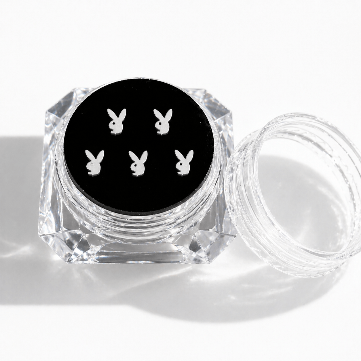 Silver bunny tooth gems 5-piece set displayed in a clear acrylic case with a black insert on a clean white background.